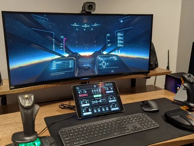 A player's desk setup running GameGlass panels on a tablet