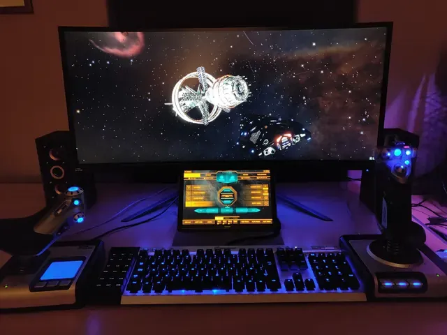 A player's desk setup running GameGlass panels on a tablet