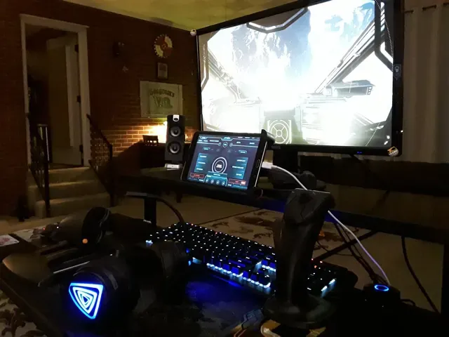 A player's desk setup running GameGlass panels on a tablet