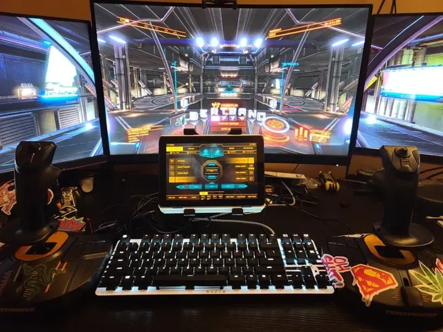 A player's desk setup running GameGlass panels on a tablet