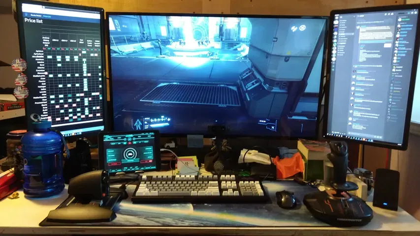 A player's desk setup running GameGlass panels on a tablet
