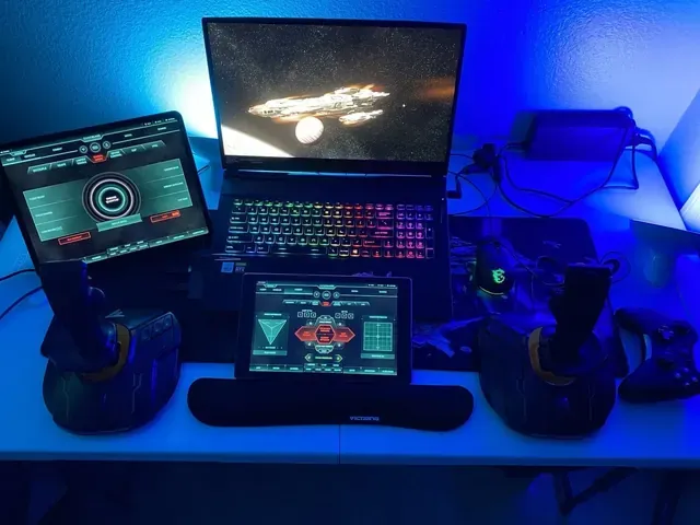 A player's desk setup running GameGlass panels on a tablet